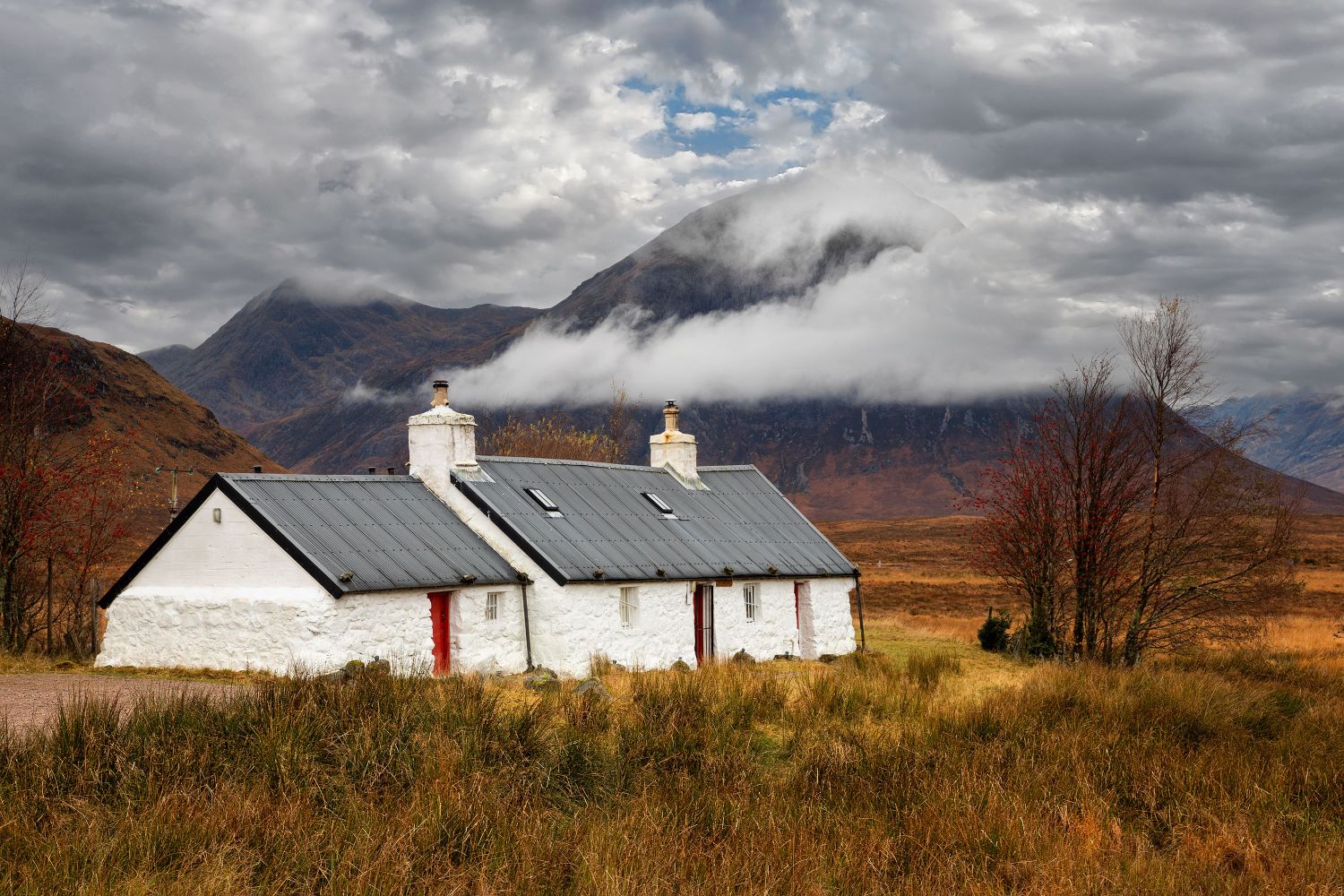 Low cloud surrounds Black Rock Cottage Glencoe by Martin Lawrence Photography