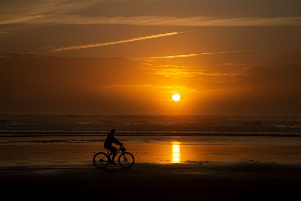 Cyclist silhouette on Cannon Beach Oregon by Martin Lawrence